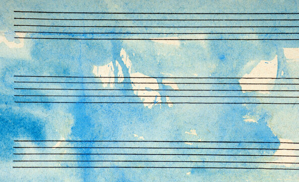 Old music sheet in blue watercolor paint. Blues music concept. Abstract blue watercolor background.