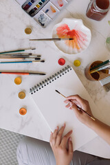 Modern artistic workspace. A young painter working in her studio.