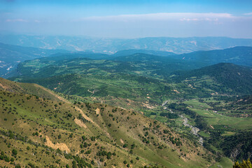 Obraz premium Idyllic summer landscape with hiking trail in the mountains with beautiful fresh green mountain pastures.