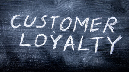 CUSTOMER LOYALTY concept. Black painted wood and inscription with chalk