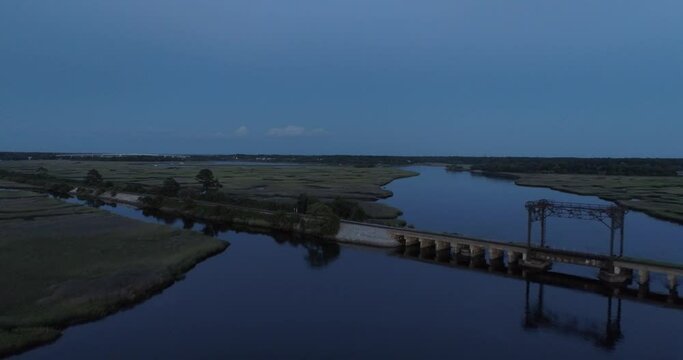 Drone clip of a train trestle in the middle of a salt water marsh.