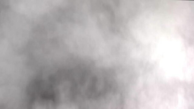 Steam, vapor from steam engine billows upwards from bottom filling the frame against black background continuing to actively produce clouds of steam and then tapers off at the end.