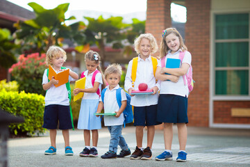 Child going back to school. Start of new school year after summer vacation. Little girl with backpack and books on first school day. Beginning of class. Education for kindergarten and preschool kids.