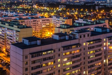 Fototapeta na wymiar View from above of the roofs of contemporary block of flats. Ulyanovsk residential district at night, Russia.