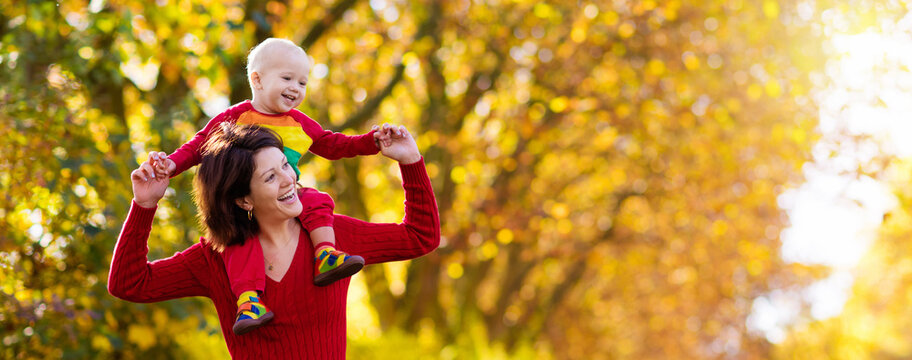 Mother and baby in autumn. Fall outdoor family fun.