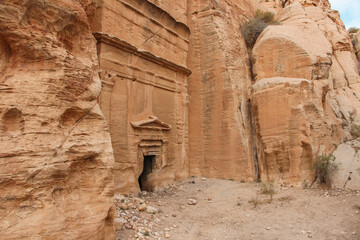 Step tomb in ancient Petra city in Jordan. The building is carved out of sandstone right into the...