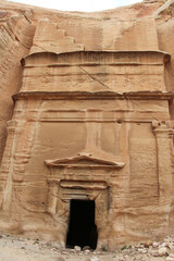 Step tomb in ancient Petra city in Jordan. The building is carved out of sandstone right into the rock. Theme of travel in Jordan.