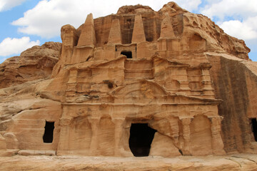Obelisk tomb in ancient Petra city in Jordan. The building is carved out of sandstone right into the rock. Theme of travel in Jordan.