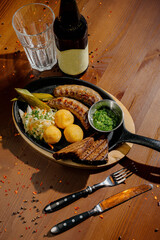 Fried potato and bavarian sausage.Top view