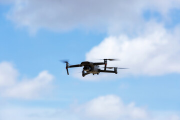 Fototapeta na wymiar A flying drone armed with camera
