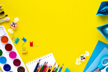 School colorful stationery on yellow background with copyspace