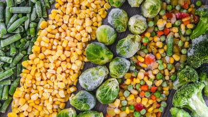 Different frozen vegetables as background, top view. Stocking up vegetables for winter storage. Assortment of frozen vegetables - obrazy, fototapety, plakaty