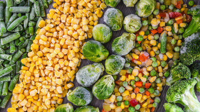 Different frozen vegetables as background, top view. Stocking up vegetables for winter storage. Assortment of frozen vegetables