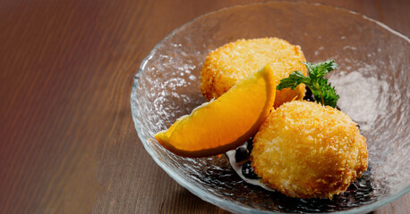 potato croquette balls with sauce on a plate.Top view
