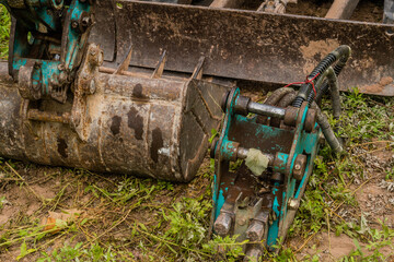 Shovel attached to hydraulic arm of small backhoe