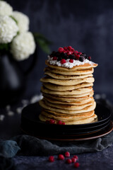 Stack of pancakes with blueberries and maple syrup for breakfast