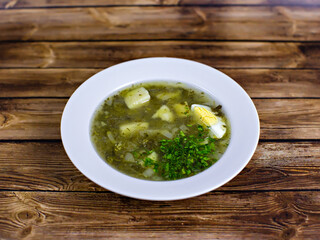 Green sorrel soup with potatoes and egg
