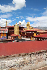 Gilded bell and Wheel of Dharma on the top of the roof at Jokhang Temple in Lhasa, Tibet, China