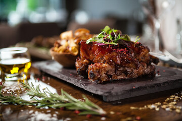 Pork ribs cooked at low temperature. Blackcurrant sauce, parsnip chips with Parmesan cheese. Delicious healthy meat food closeup served on a table for lunch in modern cuisine gourmet restaurant