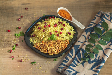 Poha rice flakes breakfast menu. Poha is easy, delicious and healthy breakfast recipe, popular in India. potatoes , onions and seasoning like chilly, lemon and curry leaves, nuts and pomegranate.