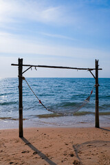Obraz premium Romantic cozy hammock on the tropical beach by the sea. Peaceful seascape. Relax, travel concept, travelling.