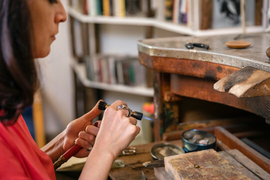 Crop jeweler preparing gas torch for work - Powered by Adobe