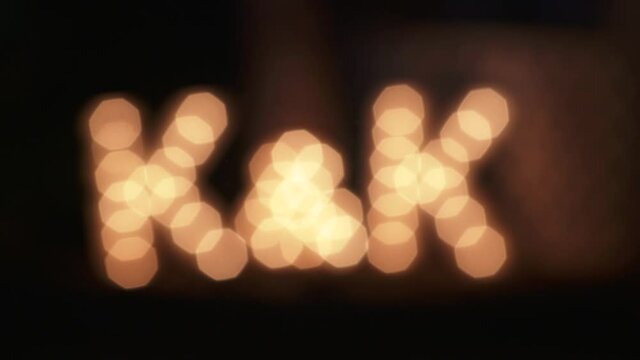 K&K light bulb letter display at wedding event. Camera racks out of focus. 