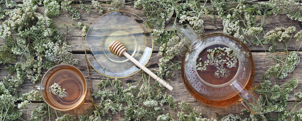 Herbal medicinal background.Healthy tea with yarrow flowers on a wooden rustic table. Place for text.
