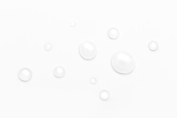 drops of water on a white background, top view