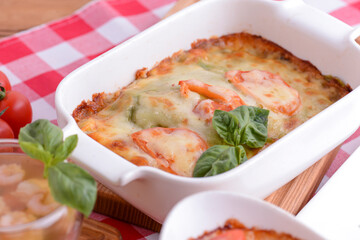 Italian lasagna in a ceramic plate. Hot and healthy dinner. Traditional cuisine. Italian concept.