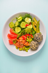 Fresh and organic vegetable salad with raw veggies - tomatoes, cucumbers, avocado. Flat lay, copy space banner.