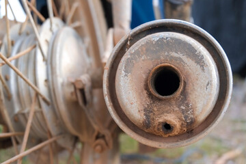 Old exhaust of motorcycle close-up.