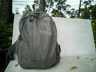 A backpack placed on a white bench