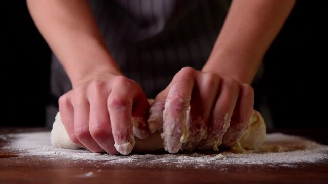Woman chef prepares the dough for baking bread