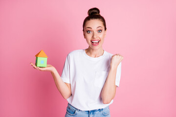 I'm gonna buy this house. Photo of attractive lady bun hairdo hold little paper house real estate dream low price enjoy agent offer wear white t-shirt isolated pastel pink color background