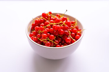 Fresh berries red currants in a white plate 