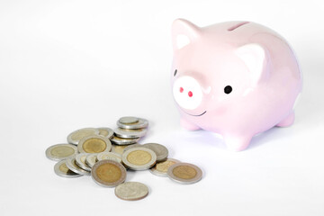Saving money concept, Piggy bank and coins stacks on white background.