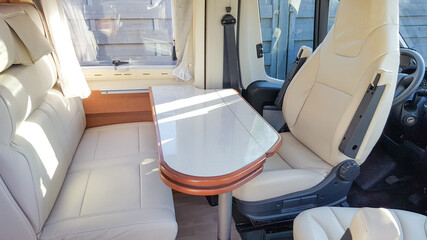vacation campervan with white interior table wooden and seat in modern new motor home on vanlife concept
