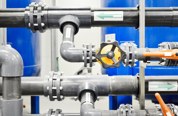 PVC pipeline an industrial city water treatment boiler room. Valves and pipe conections.