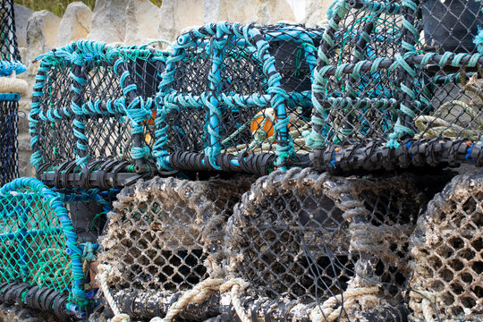 Blue and brown lobster pots at the seaside
