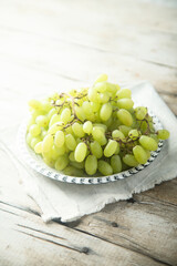 Ripe white grape on a wooden desk