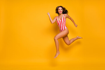 Fototapeta na wymiar Full length body size view of her she nice attractive chic cheerful slim slender fit lady jumping running having fun enjoying weekend isolated on bright vivid shine vibrant yellow color background