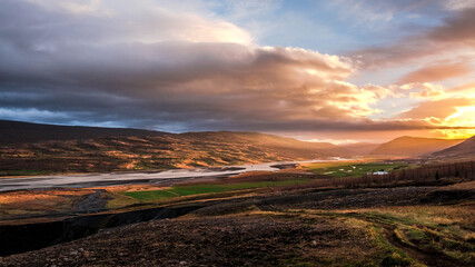 Fototapeta premium On the way up to the Litlanesfoss waterfall, East Iceland, a sunset landscape