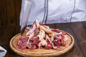 Raw fresh beef rib eye steak and seasoning on wooden background