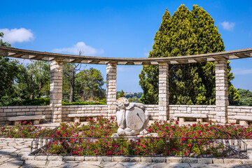 Sundial and blooming rose garden