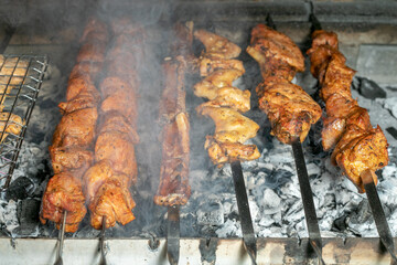 Grilling marinated shashlik on a grill. Shashlik is a form of Shish kebab