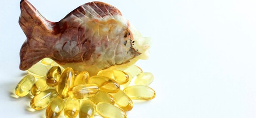 Omega 3 capsules lying on white background. Fish oil in pills. Health support and treatment. Biologically active additives.
