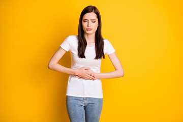 Portrait of frustrated girl touch her stomach suffer pms food poisoning wear casual style white...