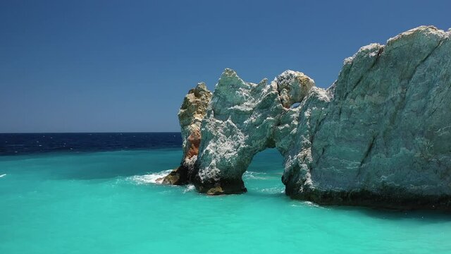 Aerial drone rotational video of Lalaria arch in famous turquoise beach, one of the most beautiful in Greece, Skiathos island, Sporades islands