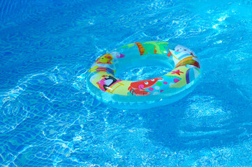 close-up - bright children's inflatable swimming ring floats in the pool
